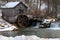 Rural landscape with abandoned watermill in forest