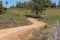 Rural landscape and the dirt road in front of the small farm