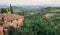 Rural landscape with gardens and roofs of mansions at evening Tuscany. Green trees, countryside in province of Italy