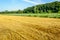 Rural landscape with a grain stubble field in the foreground