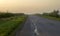 Rural landscape in the morning mist, empty road,