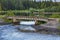 Rural landscape with narrow stone footbridge in summer