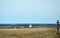 Rural landscape. Orthodox wooden cross beside the road. Church. Spring.