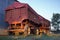 Rural landscape: Pair of carts to transport cereal to the side of a barn.