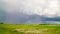 Rural landscape, rain clouds and rainbow, time-lapse