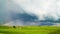 Rural landscape, rain clouds and rainbow, time-lapse