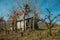 Rural landscape with a shabby shack next to trees