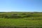 Rural landscape. Siberian Village. Harvested hay rolls. Wooden houses with gardens.