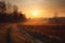 rural landscape with sun setting behind the horizon, casting warm colors across the sky