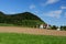 Rural landscape in Switzerland: hill  forest  meadows and a farm