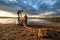 Rural landscape two fishermen, father and son, gather a seine for fishing in fishboat in yakutian village, Yakutia, Russia