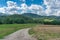 Rural landscape with unsealed road and green hills