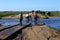 Rural living - villagers pushing their bicycles across flooded road