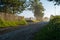 Rural macadam road that runs between wooden fences