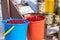 Rural market. Sale of winter blanks on the street counter in winter in the snow. Berries of viburnum, mountain ash in buckets.