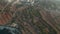 Rural Mediterranean Countryside fly over Brown dry Agriculture Fields revealing Factory by the Water on Malta Island