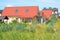 Rural modern house with red roof, balcony and skylight