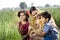 Rural mother with children in agricultural field