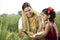 Rural mother and daughter using mobile phone on agriculture field