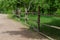 Rural path enclosed with lath fence at summer