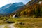 Rural picturesque area in Slovenia with wooden sheds in focus.