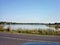 Rural pond on the Central Russian hill with a beach on the shore