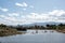 Rural pond with distant mountains in summer