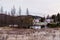 Rural property with old French style house and barns on lake with the Laurentian mountains in the background