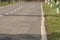 Rural road with asphalt patches as a background