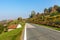 Rural road and autumnal hills in Piedmont, Italy.