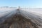 The rural road going among snow fields