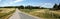 Rural road and landscape with the white Ekenas castle on a cloudy day, Sweden