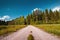 Rural road perspective under blue sky