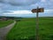 Rural road with sign post, Cantabria, Camino del Norte route, Northern coast of Green Spain