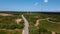 Rural road and telecommunication antennas at the end of a road amidst lavender fields