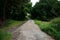 Rural road with a weir crossing over a creek