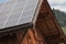 Rural scene of an alpine barn with photovoltaic panels