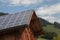 Rural scene of an alpine barn with photovoltaic panels