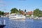 Rural scene on the banks of the river Ryck in Northern Germany with sailing boats and a historic steamer