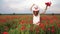 Rural scene, female hand stroking red poppies flowers. Large field of wild poppies, beauty nature concept