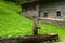 Rural scenery with wooden water well and a old alpine hut near Falzthurnalm. Achensee Lake area, Austria, Tirol