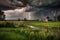 rural setting with stormy sky, lightning strikes, and rolling thunder