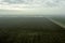 rural steppe landscape with plowed land crops road and sky with clouds