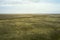 rural steppe landscape with plowed land crops road and sky with clouds