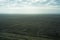 rural steppe landscape with plowed land crops road and sky with clouds