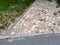 rural stone paving urban square made of quartz cobbles size about 15cm joints filled with gravel brown beige white yellow color