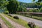 Rural street with an original fence and large boulders