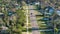 Rural street traffic with driving cars in Florida small town. American suburban landscape with private homes in quiet