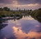 Rural Sunny Water Scene - Pond of water with a sunny reflection of clouds and trees in a wooded rural sea