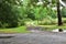 Rural Texas muddy driveway with tire ruts and swing gate